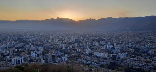 an aerial view of a city at sunset at ALSIGAL COCHABAMBA Casa de Huéspedes in Cochabamba