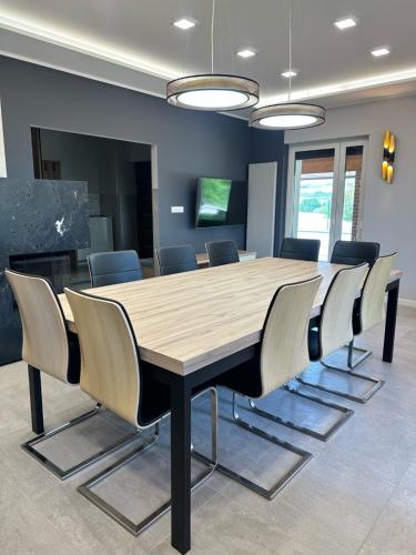 a conference room with a wooden table and chairs at Villa Chiara Piemonte in San Salvatore Monferrato