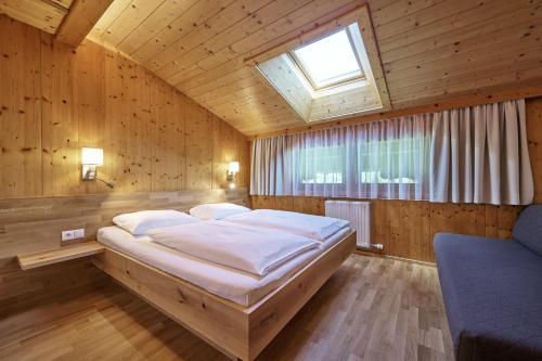 a bedroom with a large bed and a window at Landhaus Huber in Altenmarkt im Pongau