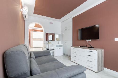 a living room with a couch and a flat screen tv at Apart-Hotel President in Ulcinj