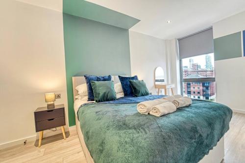 a bedroom with a large bed with towels on it at Stunning Liverpool Apartment - Sleeps 6 in Liverpool