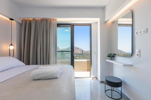 a bedroom with a bed and a view of the ocean at Epsilon Villa, Private Swimming Pool Garden, Panoramic Sunset in Rethymno Town