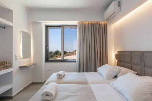 a bedroom with a large bed with a large window at Sigma Villa, Private Swimming Pool Garden, Panoramic Sunset in Rethymno Town