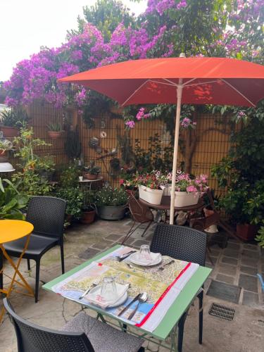 a table with an umbrella on a patio at The Tower Of The Old King in Desenzano del Garda
