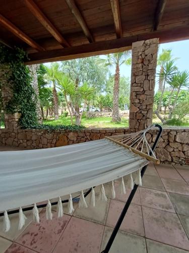 a hammock on the porch of a house at Claudia vacanze in Torre Suda