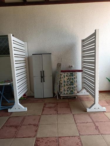 a room with a refrigerator and two open doors at Claudia vacanze in Torre Suda