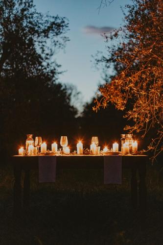 a table with lit candles on it at night at Agriturismo Terra Di Dio Toscanizzazione in Capannoli