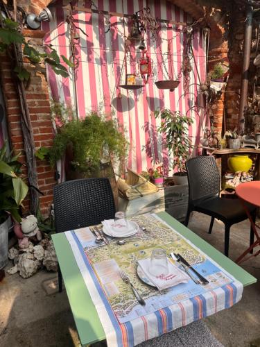 a table with plates and utensils on it at The Queen Tower in Desenzano del Garda