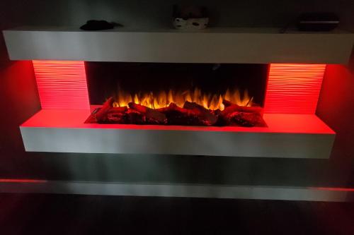 a fireplace with red lights in a room at Blue Ridge Delight in Clayton