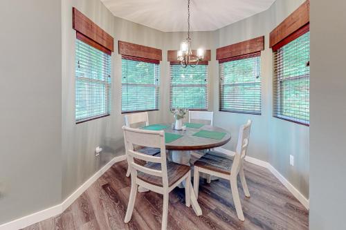a dining room with a table and chairs and windows at Blue Ridge Delight in Clayton
