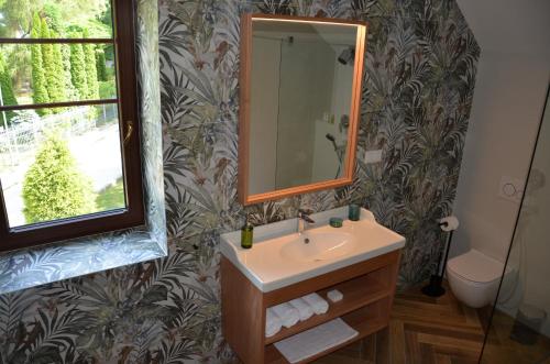 a bathroom with a sink and a mirror at FloraVilla in Rajecké Teplice