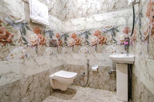a bathroom with a toilet and a sink at FabHotel Meridian Inn in Mohali
