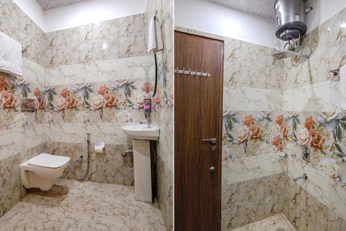 a bathroom with a toilet and a sink at FabHotel Meridian Inn in Mohali