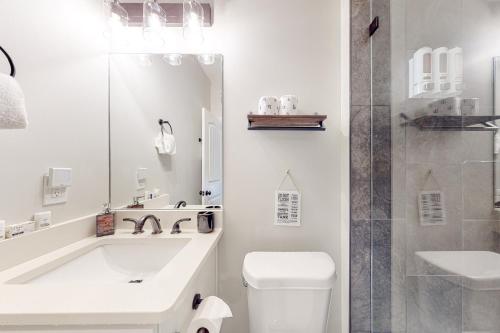 a bathroom with a tub and a toilet and a shower at Blue Ridge Delight in Clayton