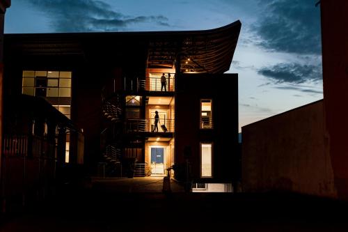 a building with its lights on in the evening at Luna Nova Rooms in San Valentino Torio