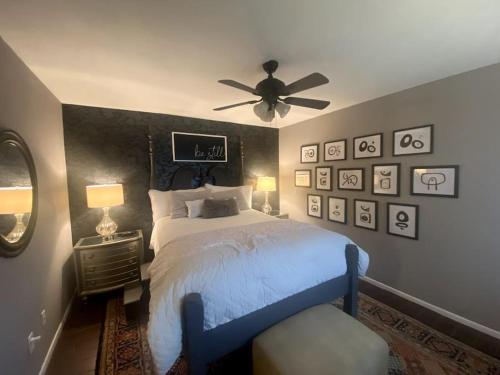 a bedroom with a bed and a ceiling fan at Artist Condo in Beaumont
