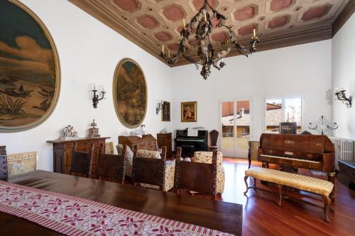 a living room with a chandelier and a table and chairs at Residenza Palazzo Marchesini in Bologna