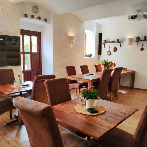 a dining room with a wooden table and chairs at Penzion Stranny in Stranný