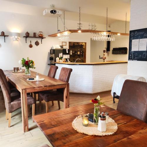 a dining room with a table and chairs and a counter at Penzion Stranny in Stranný