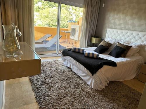 a bedroom with a large bed and a glass table at 5* Serviced Apartment Marbella in Marbella