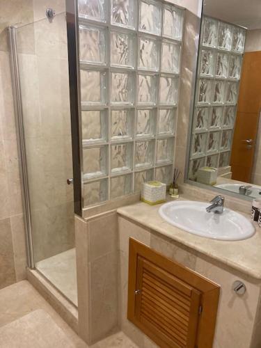a bathroom with a sink and a shower at 5* Serviced Apartment Marbella in Marbella