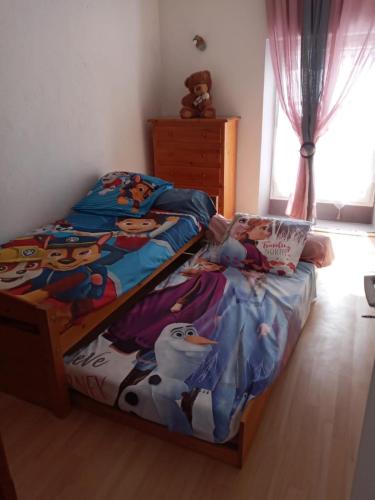 a child laying on a bed in a bedroom at Maison au Pied du Pont du Gard in Remoulins