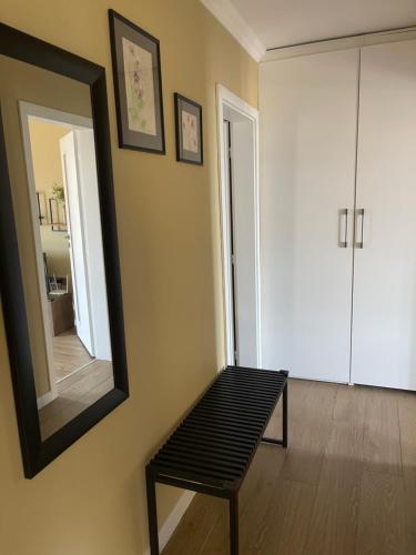 a living room with a mirror and a bench at Chernomorets Apartment in Chernomorets