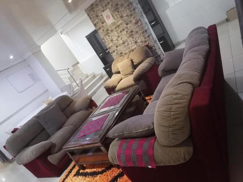 a living room with a bunch of couches at THK Properties in Pretoria