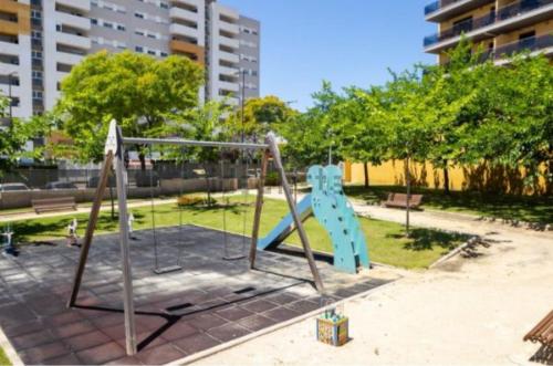 a playground with a slide in a park at Vacaciones perfectas. in Paterna