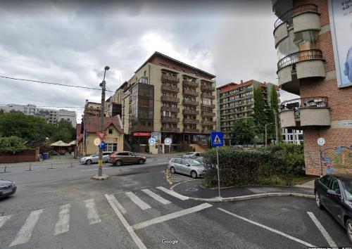 a city street with cars parked in a parking lot at The Episode - Jacuzzi Penthouses in Cluj-Napoca