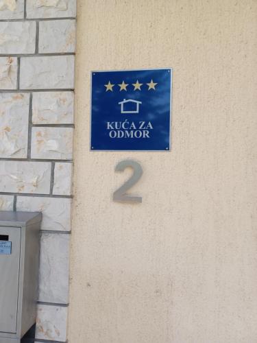 a blue sign on a wall with the number two at Vila Ava in Zaprešić
