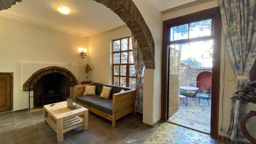 a living room with a couch and a fireplace at Old town Cozy Villa in the heart of Antalya in Antalya