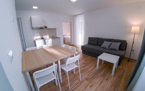 a living room with a table and chairs and a couch at Smeštaj Milutinn in Soko Banja