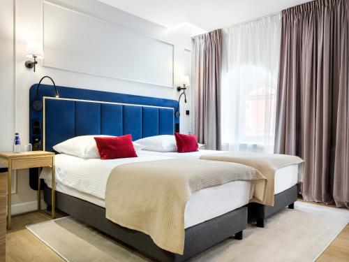 Postel nebo postele na pokoji v ubytování Hotel Golden Queen