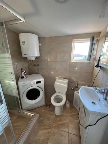 a small bathroom with a toilet and a sink at Apartment Gloria 4 NEW in Belgrade