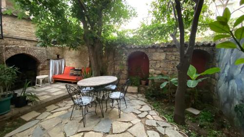 a patio with a table and chairs in a yard at Old town Cozy Villa in the heart of Antalya in Antalya