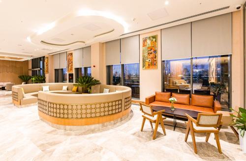 a lobby of a hotel with couches and tables at Hilton Garden Inn Samarkand Sogd in Samarkand