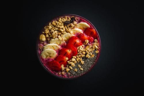 a bowl of food with fruit and nuts in it at Gravitas Hostel in Split
