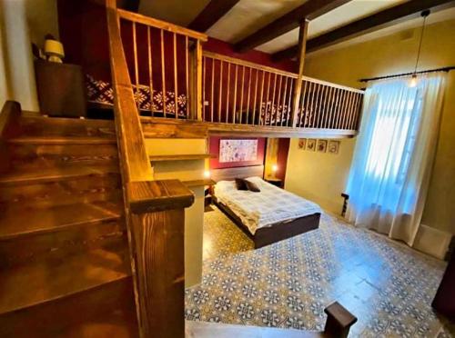a bedroom with a bed and a staircase in a house at Ta' Ciangura House of Character in Għajnsielem