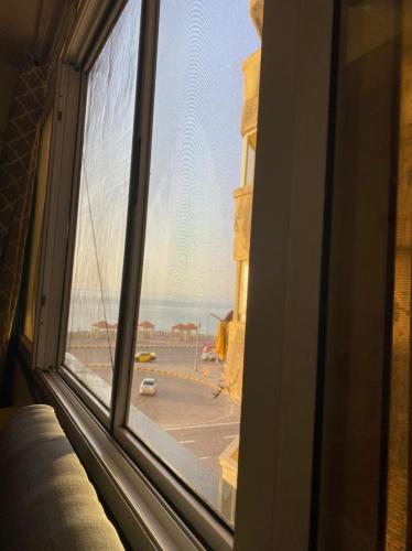 una finestra con vista su una spiaggia e sull'oceano di Campchizar sea view Apartment ad Alessandria d'Egitto
