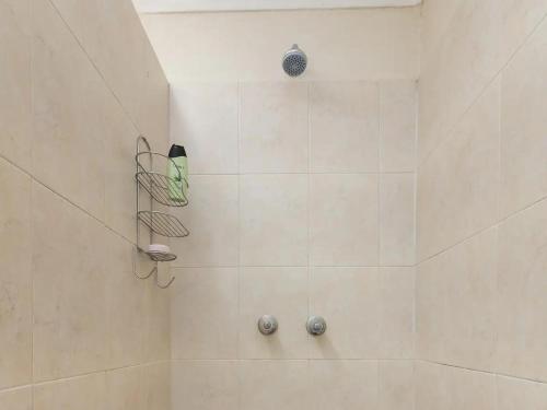 a bathroom with a shower with a shower head at Parkhurst Cottage in Johannesburg