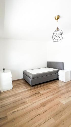 a bedroom with a bed and a wooden floor at 2 ZKB Apartment in Mannheim in Mannheim