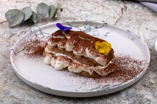 a piece of cake on a plate with flowers on it at Mula Hotel in Istanbul