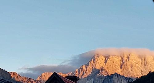 a view of a mountain with a cloud in the sky at Deluxe Apartments 55 in Kranjska Gora