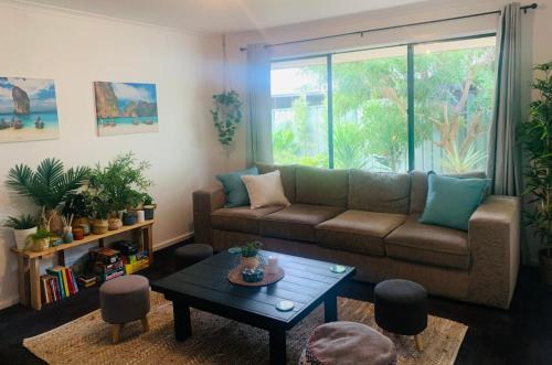 a living room with a couch and a table at Sea & Vines in McLaren Flat