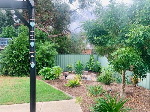 a garden with a pole with birds in a yard at Sea & Vines in McLaren Flat