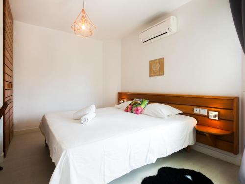 Ένα ή περισσότερα κρεβάτια σε δωμάτιο στο Tropical Cocooning