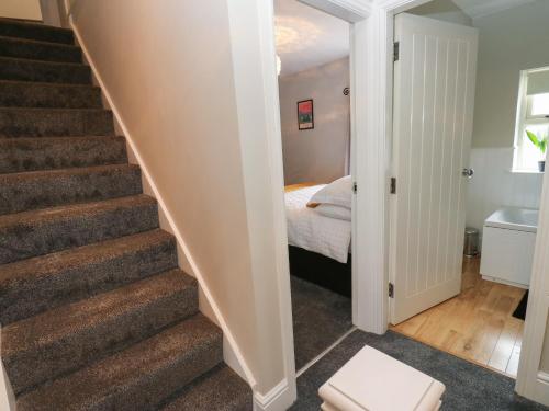 a hallway with stairs leading to a bedroom at The Moorings in Wakefield