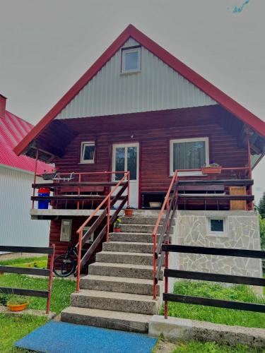 a house with stairs in front of it at Vuković Accommodation in Žabljak