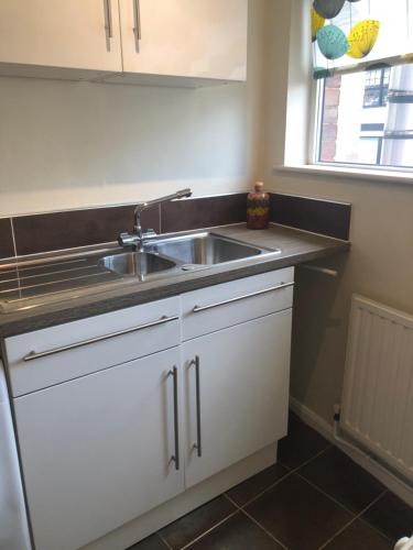 a kitchen counter with a sink and a window at HALF PRICE OFFER - Exeter City Apartment in Exeter